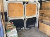 a white van that has two doors and a lot of wood on it