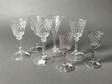 six wine glasses sitting on a table next to each other