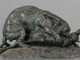 statue of a dog and a cat on a rock on a table