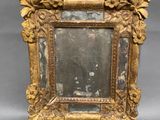 an old picture frame with a picture of a man and a woman in it