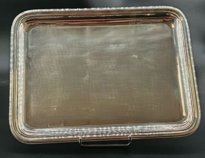a silver plated box with a handle on a black surface