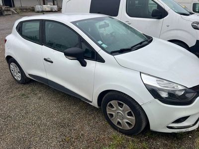 a picture of a white car parked next to a white van