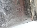 a close up of a piece of metal with a hole in it