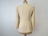 beige wool jacket on a mannequin stand