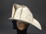 an old fireman ' s helmet on display on a mannequin head