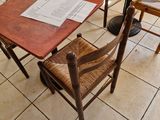 tables and chairs in a restaurant with papers on the table