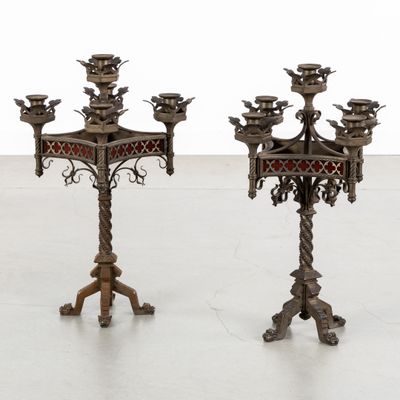 pair of antique brass candelabs with red and gold accents