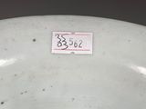 a white porcelain bowl with a small sticker on it