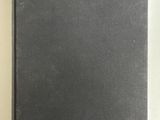 a black book with a blue sticker on it