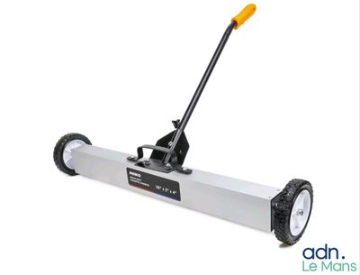 a close up of a hand operated floor sweepr on a white background