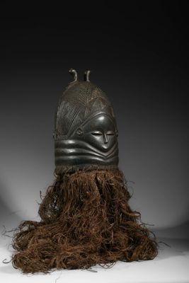 a black helmet with a long hair on top of it