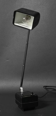 black and white photograph of a desk lamp on a black surface