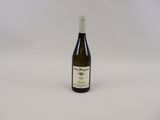 the bottle of wine is sitting on a white surface