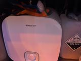 a white water heater sitting next to a bottle of beer
