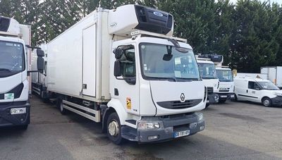 two trucks parked in a parking lot next to each other