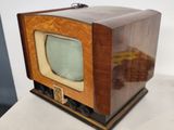 a small wooden box with a small television on top of it