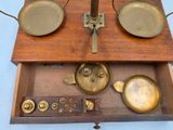 a wooden box with a scale on it and a plate on top of it