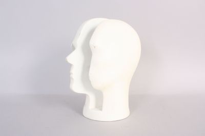 a white mannequin head sitting on a table