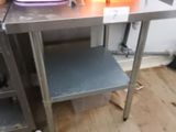 a table with a bowl on it and a bucket on it