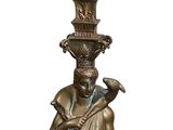 bronze statue of a man holding a vase on top of his head