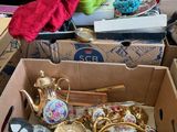 a box full of teapots and other items on the floor