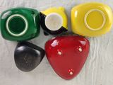 four different colored cups sitting on top of each other