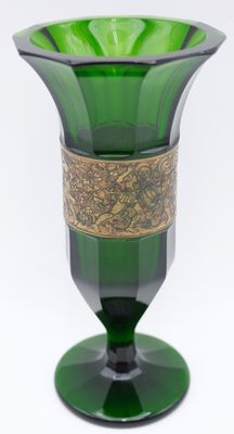 a green glass vase with a gold band around it
