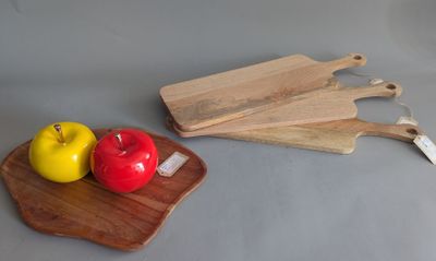 two apples on a cutting board and a knife on a cutting board