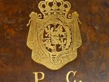 brown book with a gold emblem on top of it sitting on top of a table