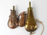 three antique brass vases with handles and handles on a white surface