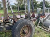 a tractor that is sitting in the grass near a fence