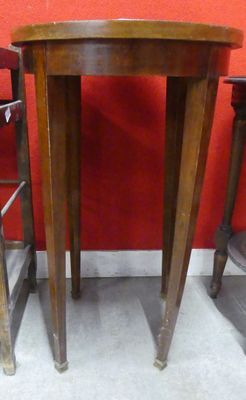 three wooden stools and a table in a room with a red wall