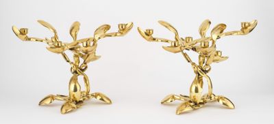 pair of gold plated candlesticks with flowers and leaves