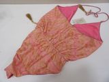 a pink and orange dress with a tag on it