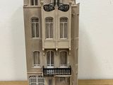 a small model of a building on a wooden table