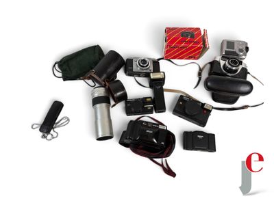 many different cameras and accessories laid out on a white surface