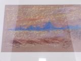 painting of a landscape in a white frame on a wall
