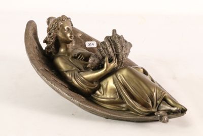 bronze figurine of a woman sitting on a boat holding a baby