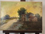 une peinture à l'huile représentant une maison, posée sur un chevalet devant un mur blanc