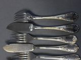 five forks and six spoons sitting on a table