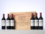 three bottles of red wine in front of a wooden box