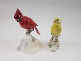 two figurines of birds sitting on top of each other