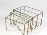 three brass and glass nesting tables on a white background