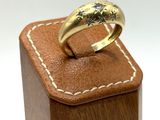 an image of a gold ring on a wooden box