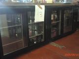a glass door refrigerator with bottles on it in a store
