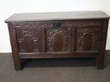 an old wooden chest with carvings on the front and sides