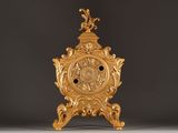 a gold clock that is sitting on a table