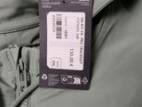 a label on the back of a jacket with a name tag