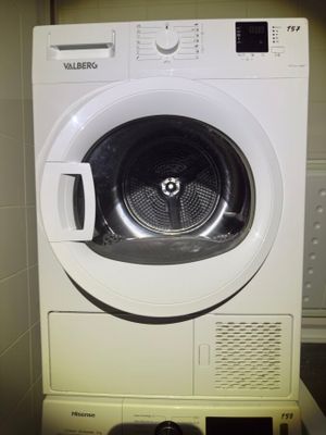 a washing machine that is sitting in the corner of a room
