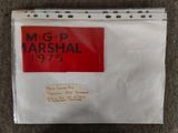 a white envelope with a red and black label on it